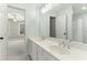 Bathroom with double sinks, framed mirror, and view into the ensuite bedroom and shower at 140 Longwater Cv, Roswell, GA 30075