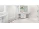 Bright bathroom boasts a modern vanity, ample storage, natural light, and a glass enclosed shower at 140 Longwater Cv, Roswell, GA 30075
