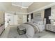 Stylishly staged primary bedroom suite with tray ceilings, modern décor, and lots of natural light at 140 Longwater Cv, Roswell, GA 30075