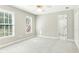 A bright bedroom with two windows, neutral paint and carpet and an ensuite bathroom at 140 Longwater Cv, Roswell, GA 30075
