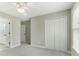 Bedroom with ensuite bath and closet, neutral walls and carpet, and ceiling fan at 140 Longwater Cv, Roswell, GA 30075