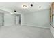 This bonus room features plenty of living space, recessed lighting, and access to a balcony at 140 Longwater Cv, Roswell, GA 30075