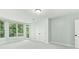 This bonus room features large windows, a door to a balcony, and a large storage closet at 140 Longwater Cv, Roswell, GA 30075