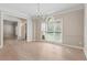 Bright dining room with hardwood floors, a chandelier, and neutral walls at 140 Longwater Cv, Roswell, GA 30075