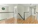 Upstairs hallway with hardwood floors, leading to multiple rooms at 140 Longwater Cv, Roswell, GA 30075