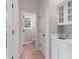 Hallway with french doors, white cabinets, sink, and view into the powder room at 140 Longwater Cv, Roswell, GA 30075