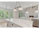 Bright kitchen features an island, stainless steel appliances, and a bay window at 140 Longwater Cv, Roswell, GA 30075