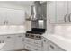 Kitchen features stainless steel appliances, white cabinets, and a range hood at 140 Longwater Cv, Roswell, GA 30075
