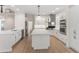 Bright kitchen features white cabinetry, stainless steel appliances, and center island with marble countertop at 140 Longwater Cv, Roswell, GA 30075