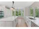 Spacious kitchen with an island and stainless steel appliances, bathed in natural light from the windows at 140 Longwater Cv, Roswell, GA 30075