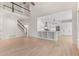 Open concept kitchen with island, stainless steel appliances, and adjacent staircase at 140 Longwater Cv, Roswell, GA 30075