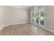 Bright living room featuring hardwood floors, natural light, and neutral paint at 140 Longwater Cv, Roswell, GA 30075