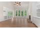 Spacious living room with fireplace, hardwood floors, and large windows overlooking the backyard at 140 Longwater Cv, Roswell, GA 30075