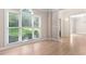 Bright living room with hardwood floors, large window, and neutral walls at 140 Longwater Cv, Roswell, GA 30075