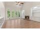 Bright living room featuring a fireplace, built-ins, and large windows at 140 Longwater Cv, Roswell, GA 30075