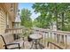 A charming outdoor balcony with seating and potted plants surrounded by trees at 2304 Country Park Se Dr, Smyrna, GA 30080