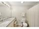 A bright bathroom featuring a granite countertop and a shower with curtain at 2304 Country Park Se Dr, Smyrna, GA 30080