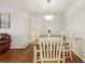 Bright dining room with a wooden table, white chairs, and elegant lighting fixture at 2304 Country Park Se Dr, Smyrna, GA 30080