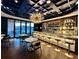 Sophisticated bar area with a unique chandelier, fully stocked shelves, and modern seating at 245 Roycroft Ln, Fayetteville, GA 30214