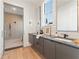 Modern bathroom with dual vanities, sleek cabinets, and a glass-enclosed shower for a spa-like retreat at 245 Roycroft Ln, Fayetteville, GA 30214