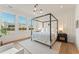 Bright bedroom features a four-poster bed, hardwood floors, and large windows offering natural light at 245 Roycroft Ln, Fayetteville, GA 30214