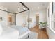 Bright bedroom features a four-poster bed, hardwood floors, and a neutral color palette at 245 Roycroft Ln, Fayetteville, GA 30214