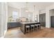 Modern kitchen featuring a central island with seating, custom cabinets, and high-end finishes at 245 Roycroft Ln, Fayetteville, GA 30214