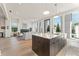 Open-concept living area with island, fireplace, and large windows, providing a bright and inviting space for entertaining at 245 Roycroft Ln, Fayetteville, GA 30214