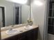 Bathroom with double vanity, dark wood cabinets, and a large mirror, offering a clean and functional space at 3554 Umatilla Sw Ln, South Fulton, GA 30331
