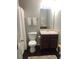 Bathroom with dark cabinets, framed mirror, and matching towels offers practical elegance at 3554 Umatilla Sw Ln, South Fulton, GA 30331