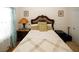 Cozy bedroom featuring patterned bedding, decorative headboard, and a classic bedside lamp at 3554 Umatilla Sw Ln, South Fulton, GA 30331