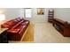 Bonus room featuring a comfortable leather couch, entertainment center, and soft carpeting at 3554 Umatilla Sw Ln, South Fulton, GA 30331