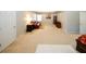 A bonus room with carpeted flooring, a tray ceiling, and a sitting area with a red leather couch at 3554 Umatilla Sw Ln, South Fulton, GA 30331