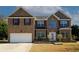 Traditional brick two-story home with an attached garage and well-manicured lawn at 3554 Umatilla Sw Ln, South Fulton, GA 30331
