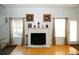 Living room fireplace with a decorative mantle and plenty of natural light streaming through the large windows at 3554 Umatilla Sw Ln, South Fulton, GA 30331