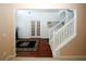 Inviting foyer with hardwood floors, elegant staircase, and detailed trim work leading into the home at 3554 Umatilla Sw Ln, South Fulton, GA 30331