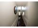 Hallway with dark wood floors, decorative trim, and a front door view, illuminated by a transom window at 3554 Umatilla Sw Ln, South Fulton, GA 30331