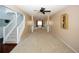 Open living area with carpeting, staircase, and views into the dining and entry area creating an airy feel at 3554 Umatilla Sw Ln, South Fulton, GA 30331