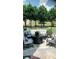 Cozy backyard patio with stone flooring, stylish outdoor furniture, and wooded scenery at 3554 Umatilla Sw Ln, South Fulton, GA 30331