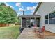 Large deck with seating, overlooking the backyard and screened-in porch with an outdoor fireplace at 4191 Secret Shoals Way, Buford, GA 30518
