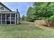 A well-maintained backyard with the corner of the sunroom visible at 4191 Secret Shoals Way, Buford, GA 30518