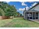 Spacious backyard featuring a wooden fence and exterior view of the sunroom at 4191 Secret Shoals Way, Buford, GA 30518