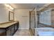 Bright bathroom featuring granite countertops, glass shower, and tile floors at 4191 Secret Shoals Way, Buford, GA 30518