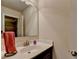 Bathroom with a black vanity, single sink, a mirror, and an open doorway to another bathroom at 4191 Secret Shoals Way, Buford, GA 30518