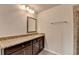 Bathroom vanity with granite countertop and framed mirror at 4191 Secret Shoals Way, Buford, GA 30518