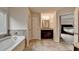 Bright bathroom with a soaking tub, vanity and access to the main bedroom at 4191 Secret Shoals Way, Buford, GA 30518