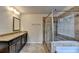 Bathroom with granite counters, tile flooring, and a tiled glass shower at 4191 Secret Shoals Way, Buford, GA 30518