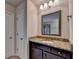 Bathroom vanity with granite countertop, framed mirror and tiled floor at 4191 Secret Shoals Way, Buford, GA 30518