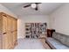 Bedroom featuring ceiling fan, bookshelves, carpet flooring, neutral walls and window bringing natural light at 4191 Secret Shoals Way, Buford, GA 30518