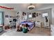 Bedroom featuring a fan light, posters on walls, an open desk, and toys filling a bin at 4191 Secret Shoals Way, Buford, GA 30518